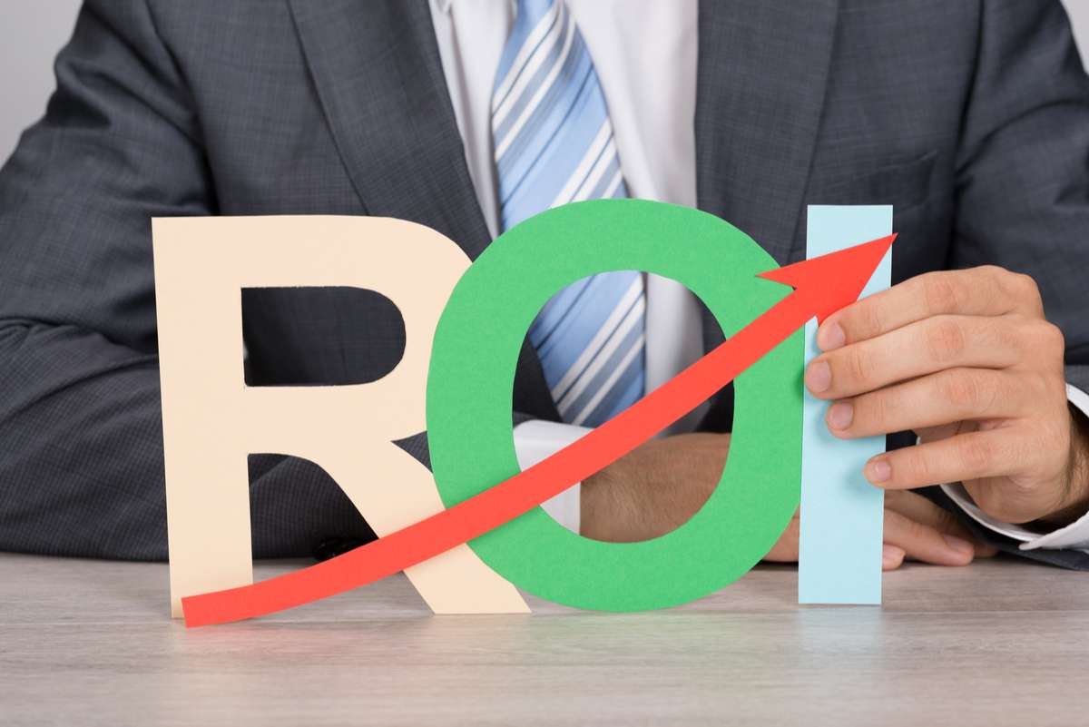 Businessman Holding ROI With Arrow (R) (S)