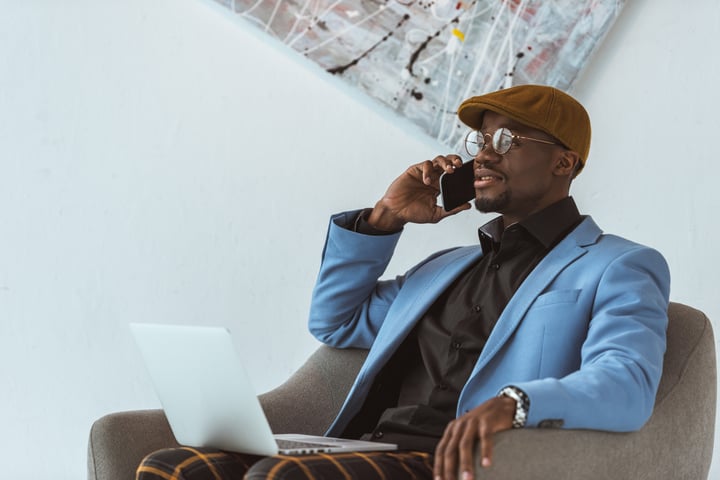 Businessman using laptop and smartphone
