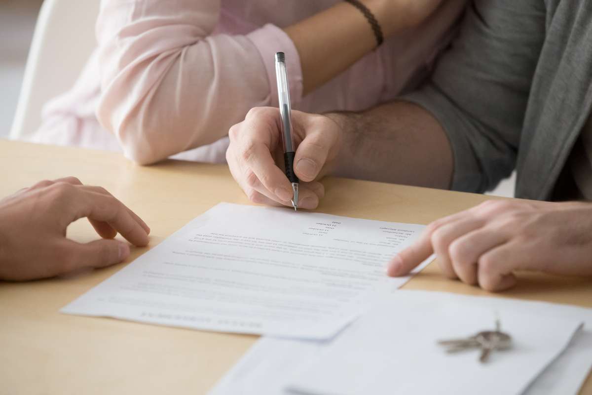 Couple signing rental sale purchase agreement buying renting house (R) (S)