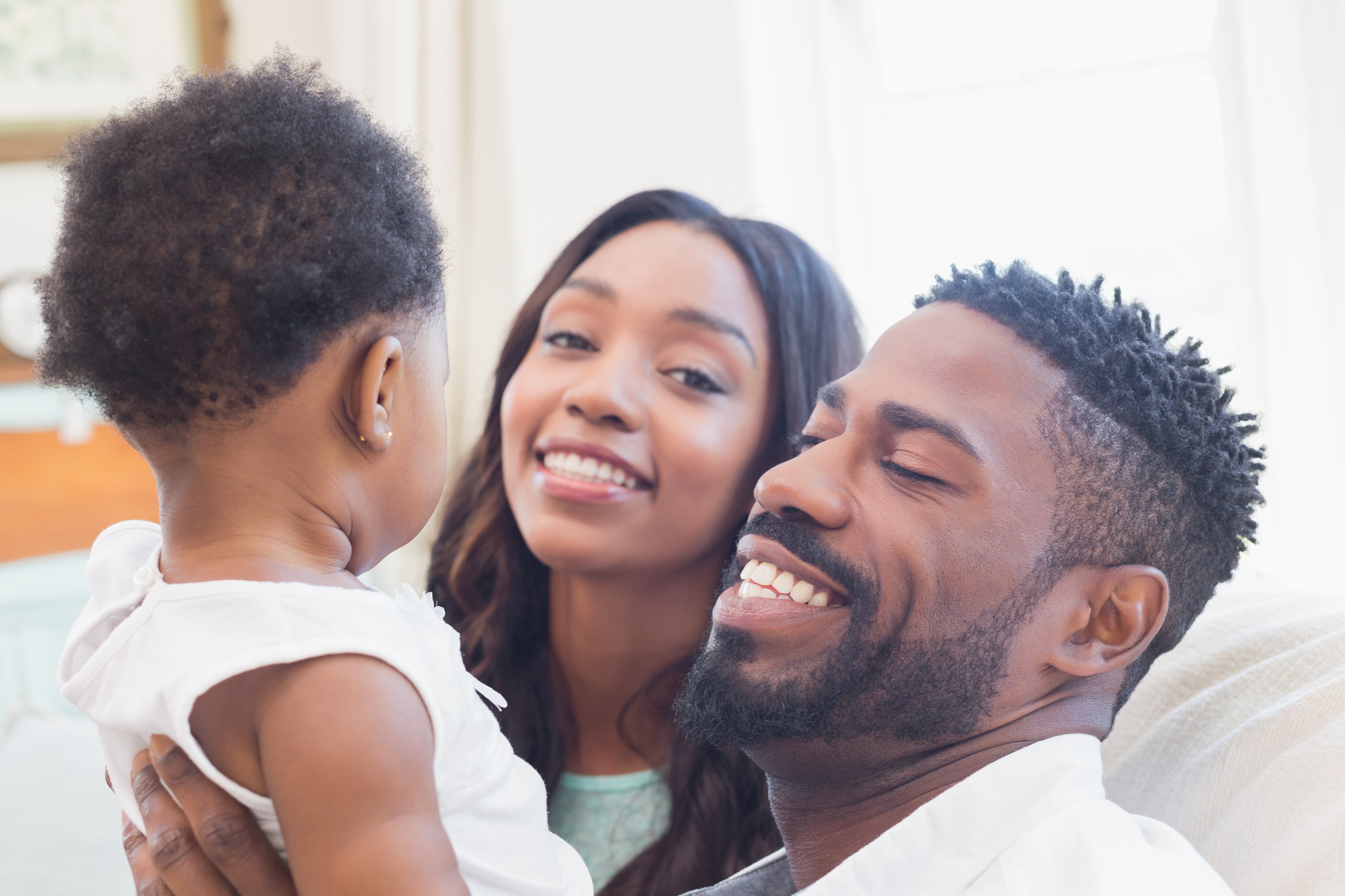 Couple with their baby girl on couch
