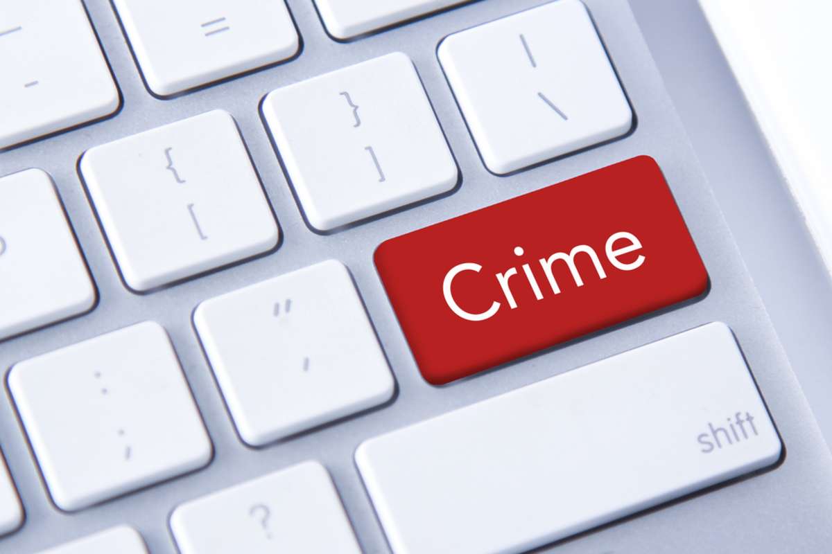 Crime word in red on a keyboard button, how crime rates impact rental property ROI concept. 