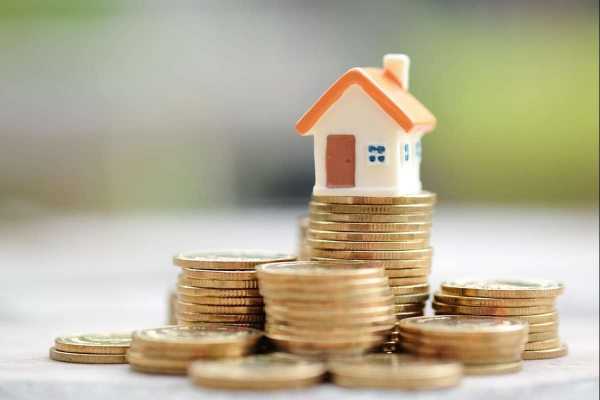 Mini house on stack of coins (R) (S)