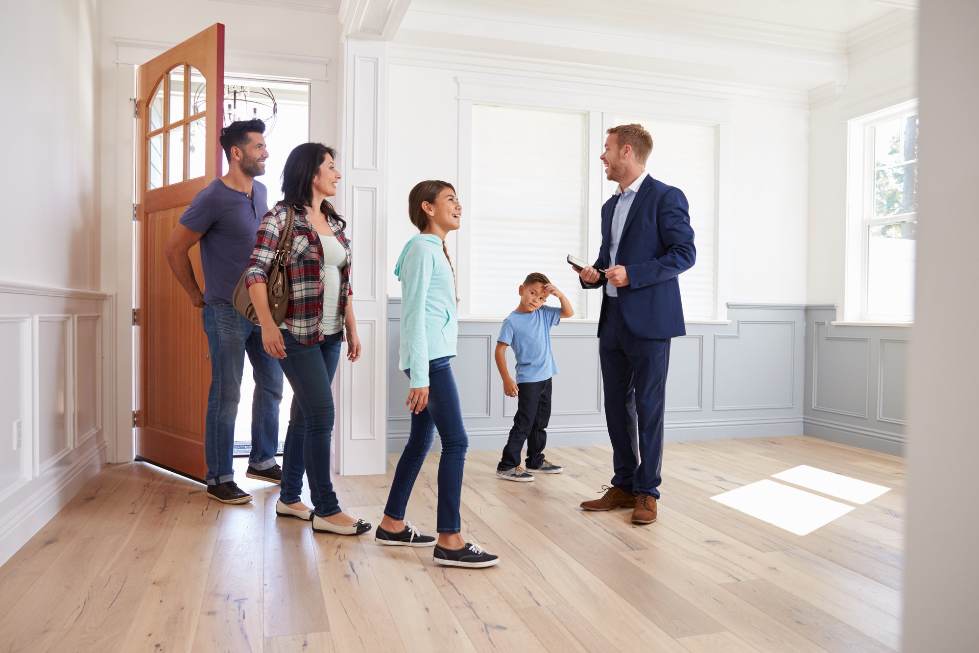 Realtor Showing Family Around Home