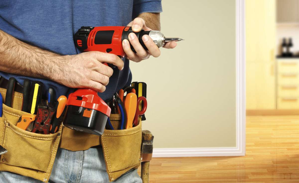 A handyman with tools and a tool belt, property management companies Delaware County concept