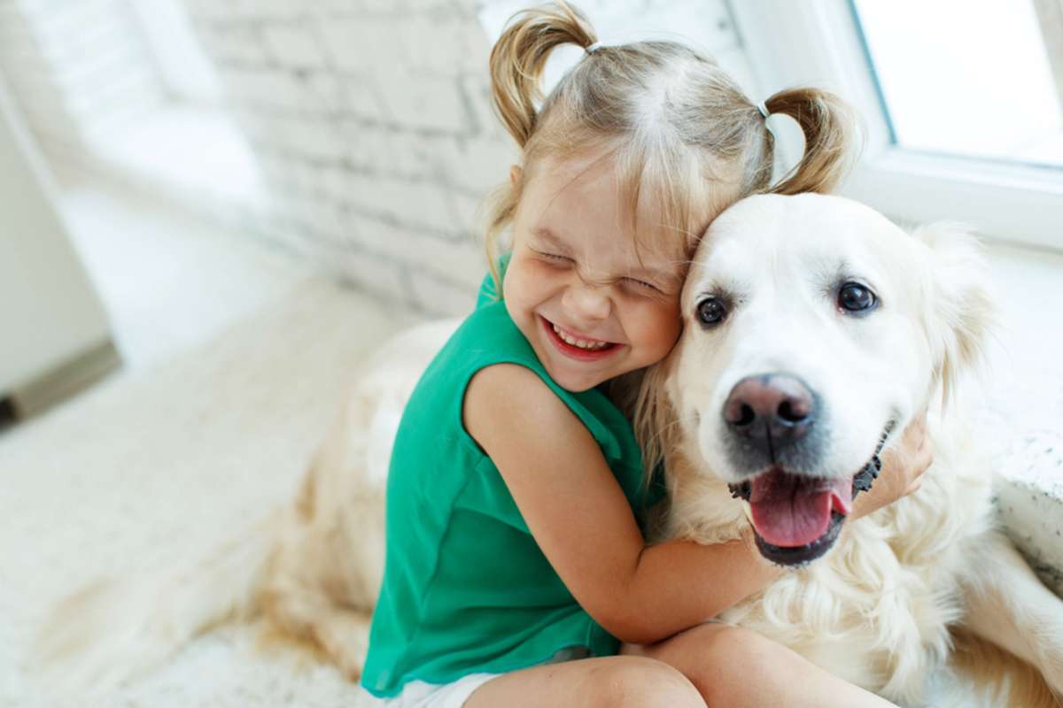 Child with dog on carpet, pet policy for rental property concept