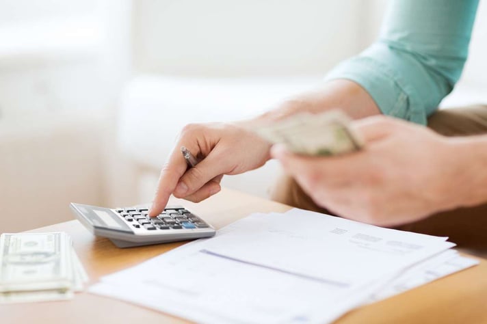 Close up of man counting money and making notes