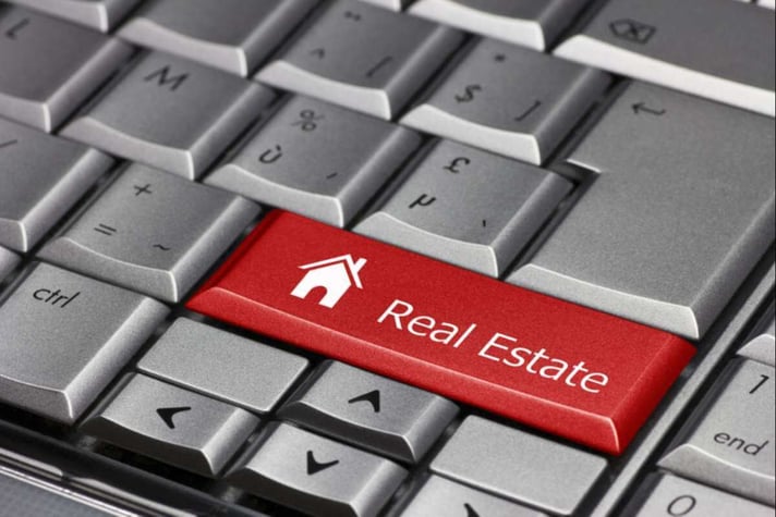 "Real Estate" on a red computer key, Philadelphia property management concept. 