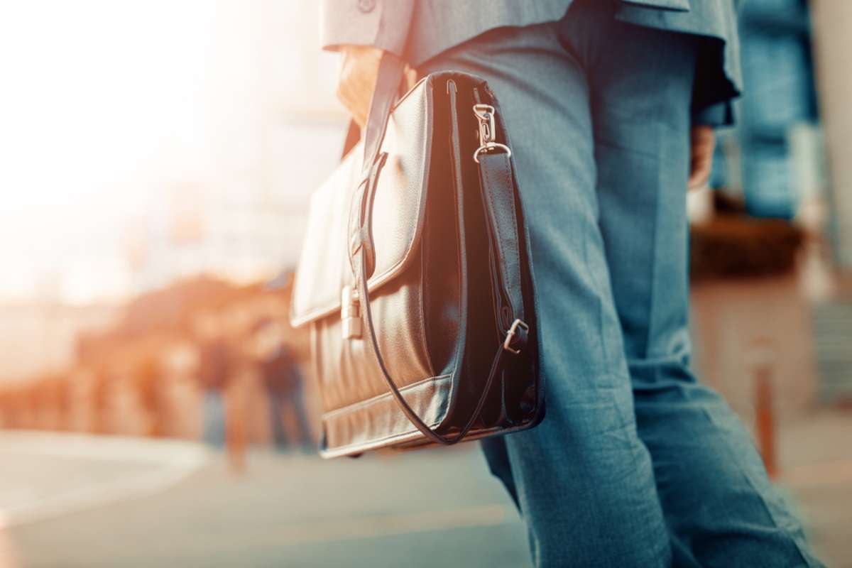 Cropped view of businessman holding a briefcase outdoors