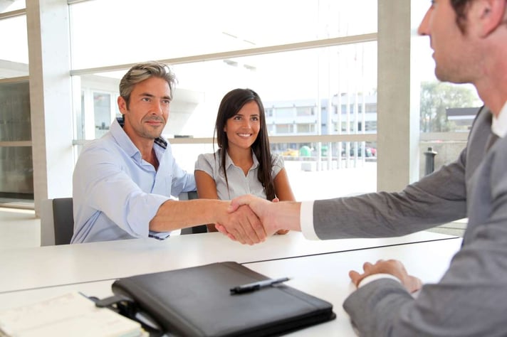 Man giving handshake to real-estate-agent