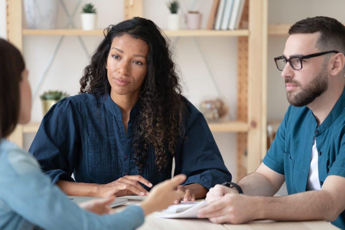 People talking around a table, property management Delaware County concept