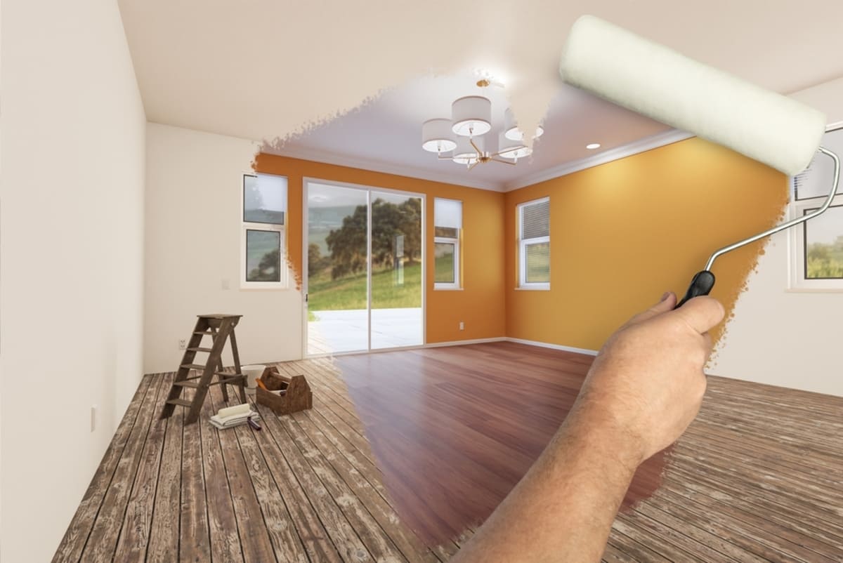 Before and After of Man Painting Roller to Reveal Newly Remodeled Room