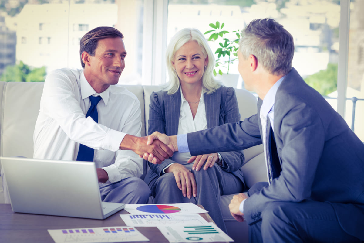 Business people reach a real estate entity agreement and shake hands