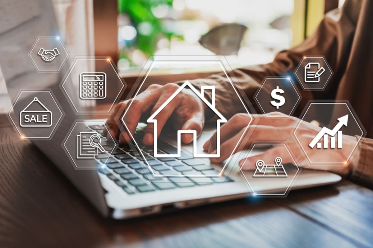 Businessman’s hands on a laptop working on different aspects of property management