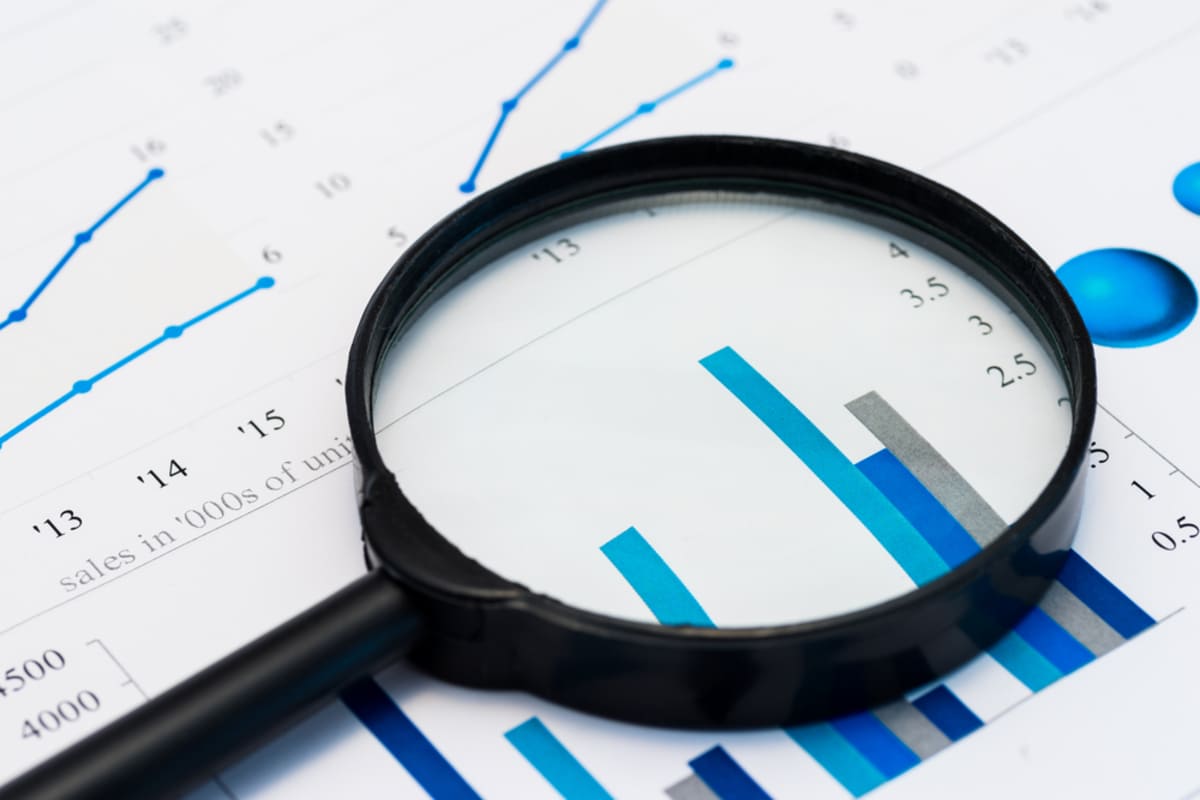 Due diligence, magnifying glass on graphs and spreadsheets
