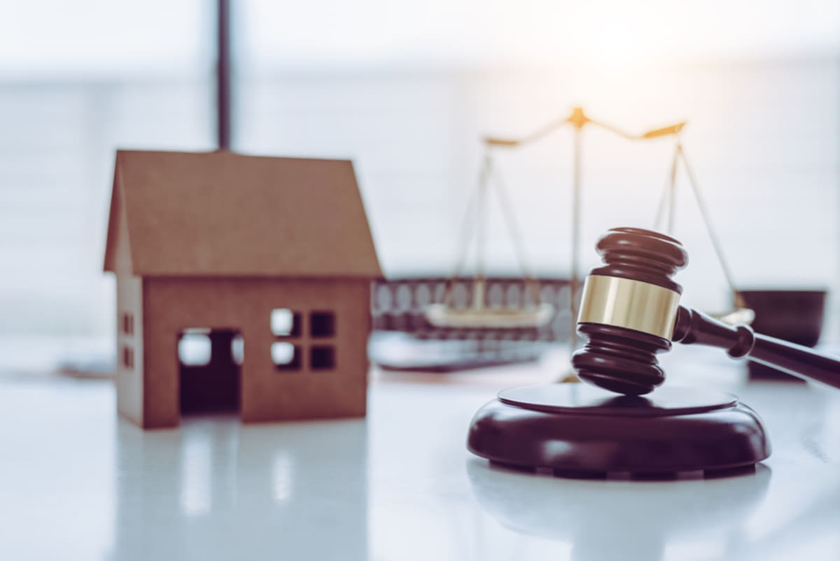 Model house by judges stick representing housing law