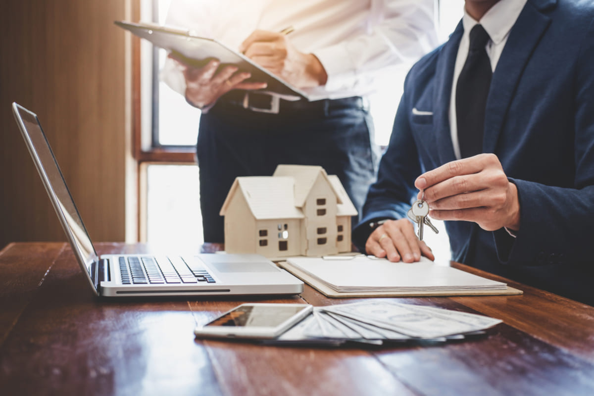 Property managers closing deal on multifamily complex