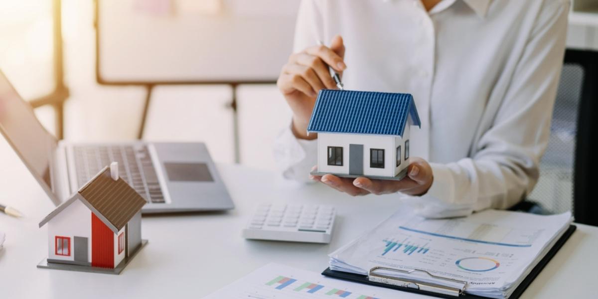 Business woman handing keys to customers along with house after customers to sign