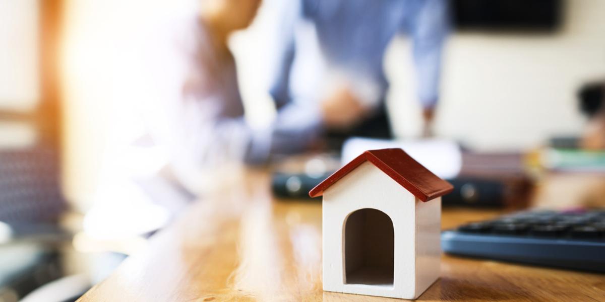 Business man working desk with financial paperwork data about loan agreement with financial institution To buy real estate