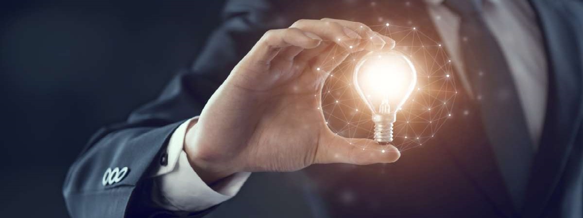 Hand of businessman holding illuminated light bulb, idea, innovation and inspiration